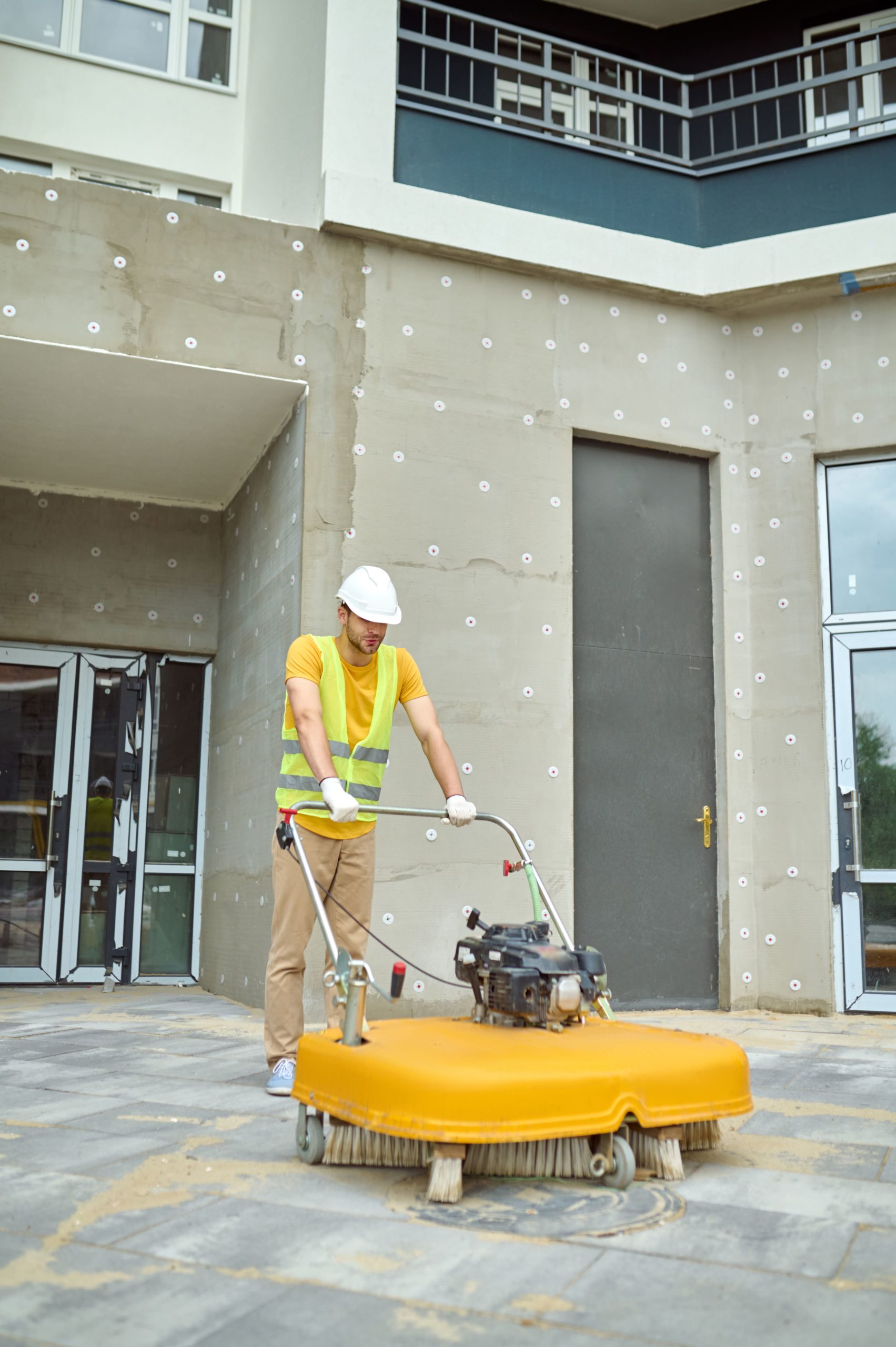 man-operating-special-equipment-cleaning-construction-site-min