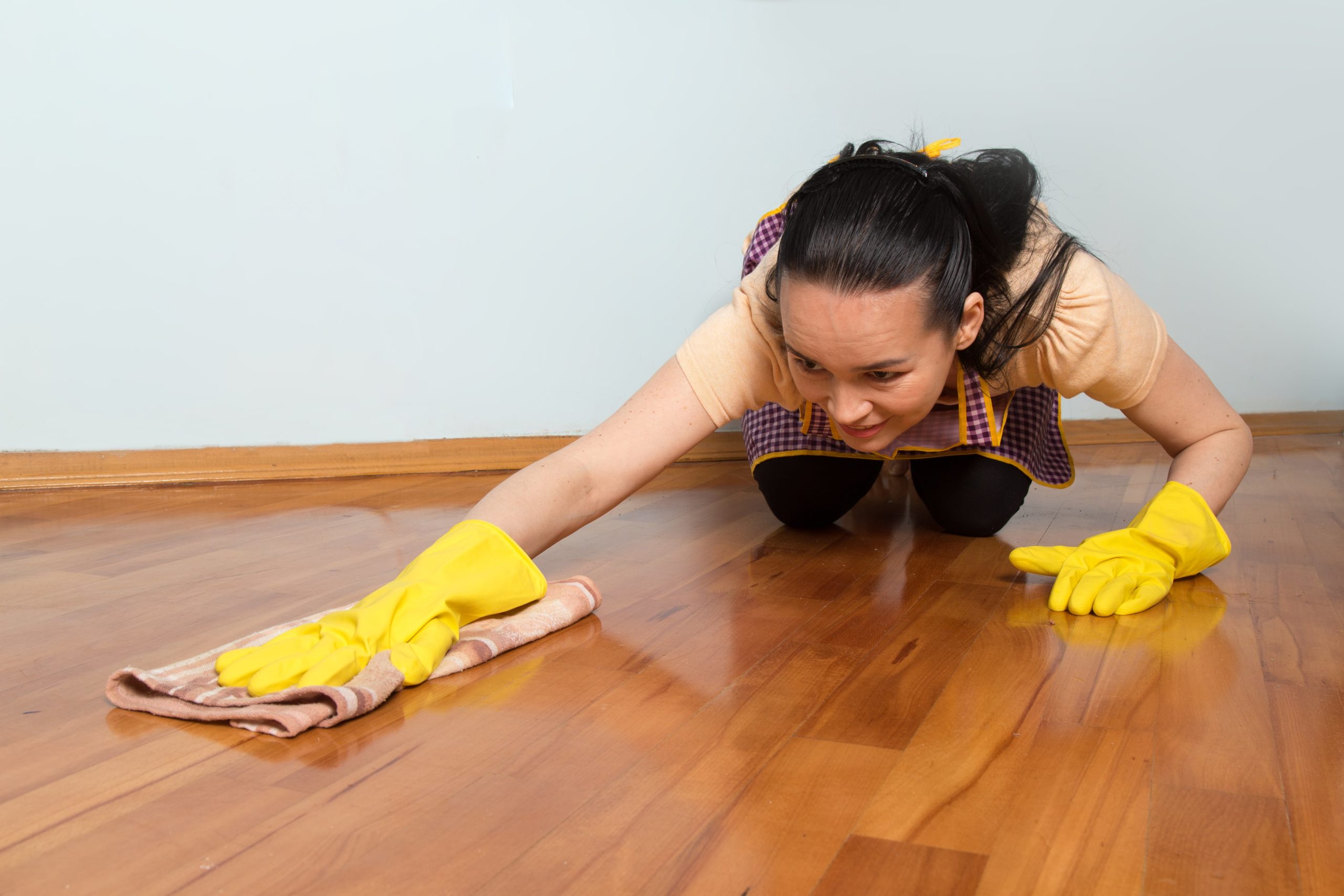 young-housewife-with-yellow-gloves-cleaning-floor-min